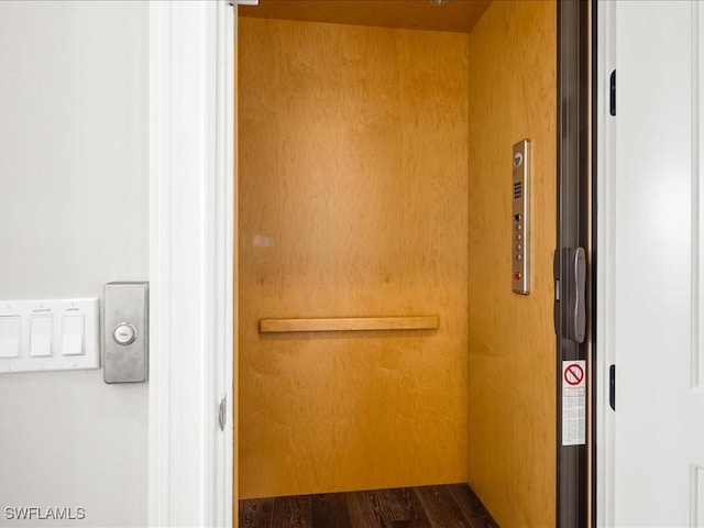 interior space with wood-type flooring and elevator