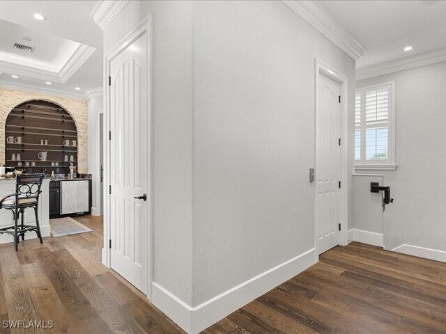 hallway with crown molding and hardwood / wood-style flooring