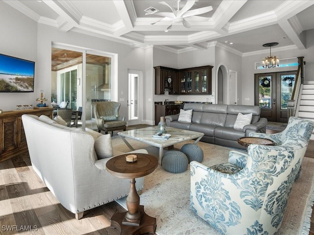 living room with french doors, ornamental molding, coffered ceiling, beam ceiling, and a high ceiling