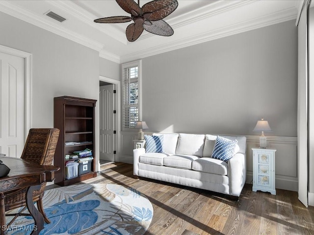 living room featuring ceiling fan, crown molding, and dark wood-type flooring