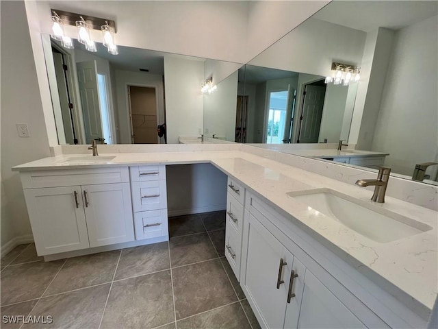 bathroom with tile patterned flooring and vanity