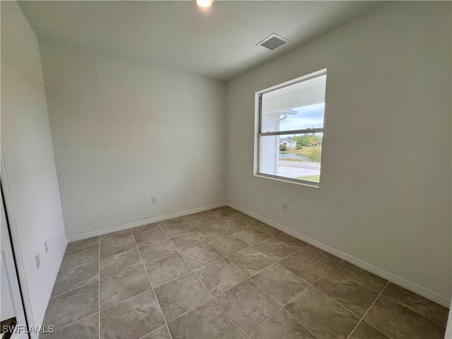 spare room featuring light tile patterned floors