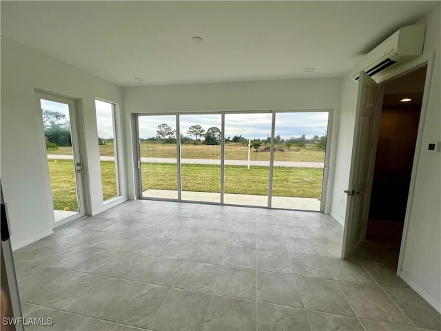 unfurnished sunroom featuring a wall unit AC