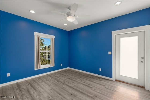 spare room featuring recessed lighting, baseboards, ceiling fan, and light wood finished floors