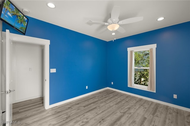 spare room with light wood-style floors, ceiling fan, baseboards, and recessed lighting