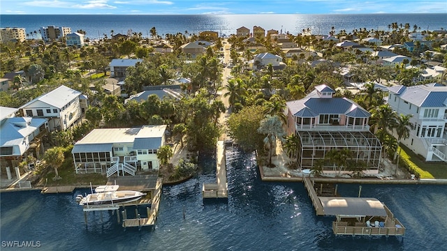 drone / aerial view with a residential view and a water view