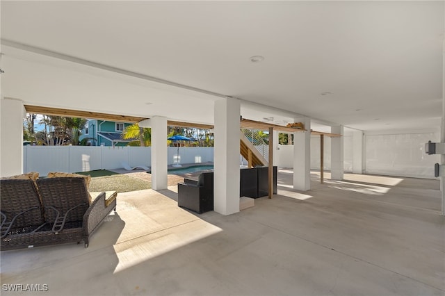 view of patio featuring a fenced backyard, stairway, and outdoor lounge area