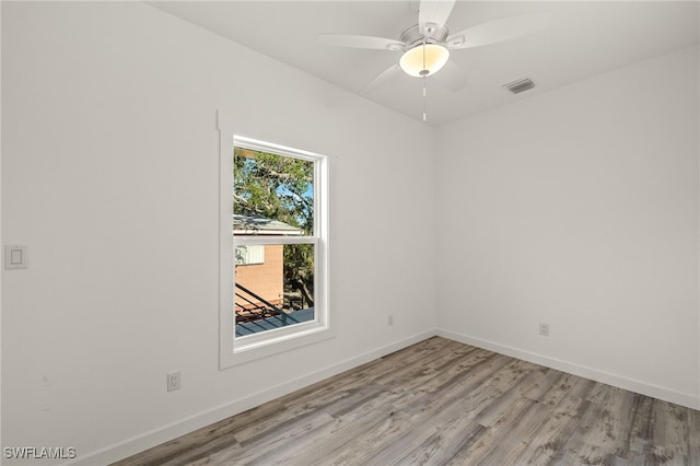 unfurnished room featuring visible vents, a ceiling fan, light wood-style flooring, and baseboards