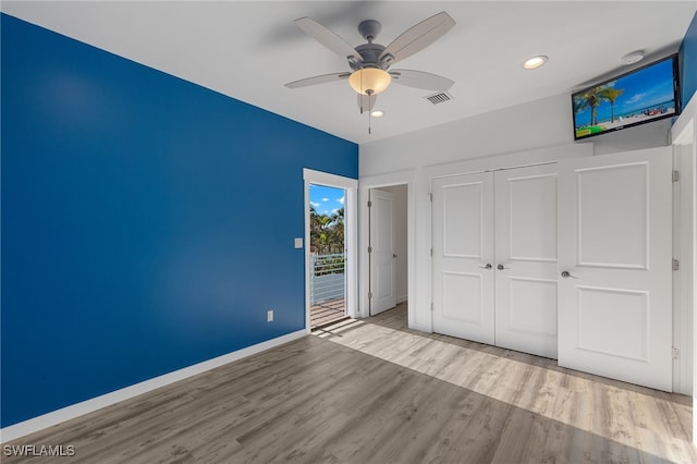 unfurnished bedroom with ceiling fan, visible vents, baseboards, a closet, and light wood-type flooring