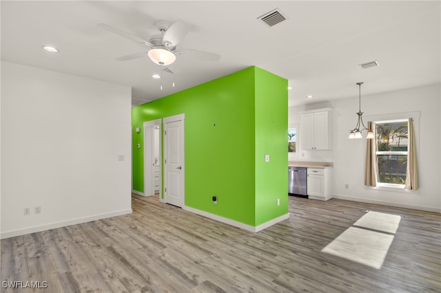 unfurnished living room with light wood finished floors, recessed lighting, visible vents, ceiling fan, and baseboards