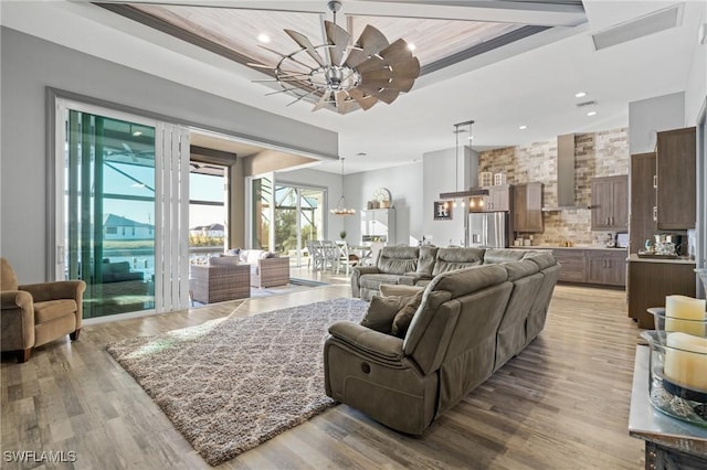 living room with ceiling fan and light hardwood / wood-style floors