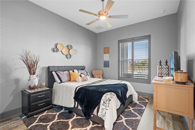 bedroom with ceiling fan and light wood-type flooring