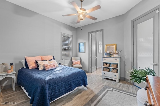 bedroom with light wood-type flooring and ceiling fan