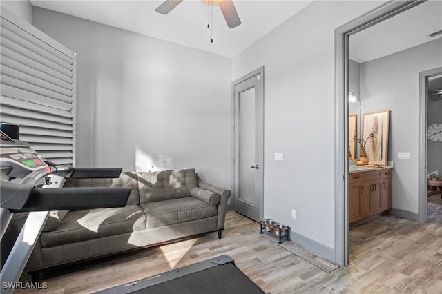 living room with light hardwood / wood-style flooring and ceiling fan