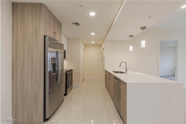 26610 Rosewood Pointe Dr Unit 308, Bonita Springs, FL 34135 - kitchen featuring stainless steel appliances, light tile patterned floors, hanging light fixtures, and sink
