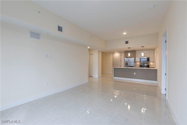 26610 Rosewood Pointe Dr Unit 308, Bonita Springs, FL 34135 - unfurnished living room featuring light tile patterned floors