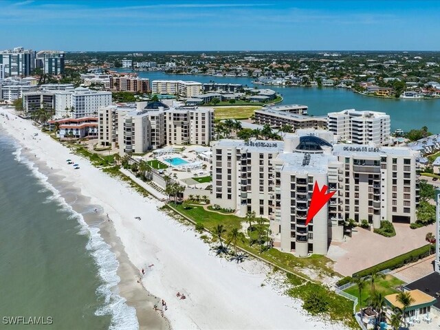 aerial view featuring a water view, a city view, and a view of the beach