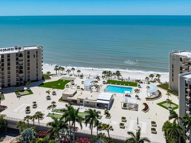 birds eye view of property featuring a beach view and a water view