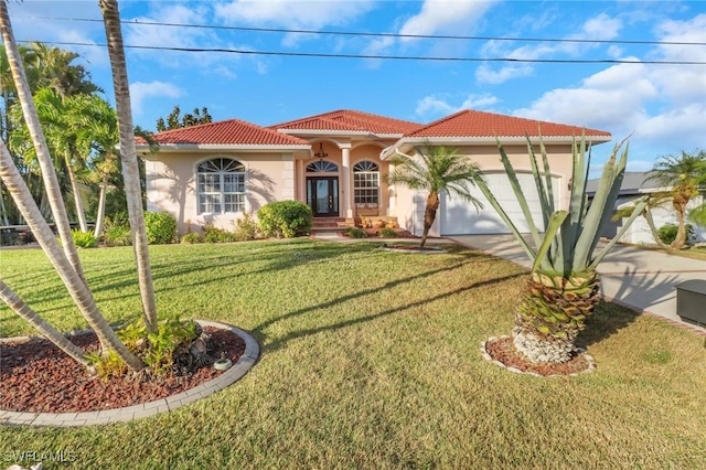 mediterranean / spanish-style house with a front yard and a garage