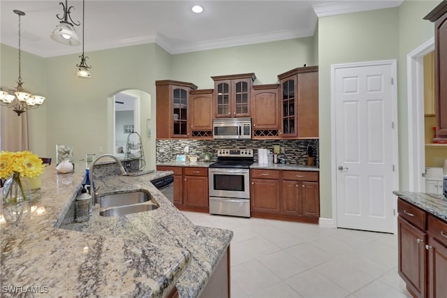 kitchen featuring appliances with stainless steel finishes, sink, light tile patterned floors, a notable chandelier, and hanging light fixtures