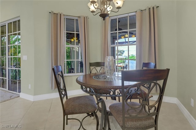 tiled dining space with a notable chandelier