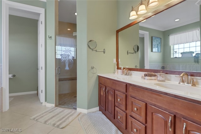 bathroom with tile patterned flooring, vanity, a shower with shower door, and crown molding