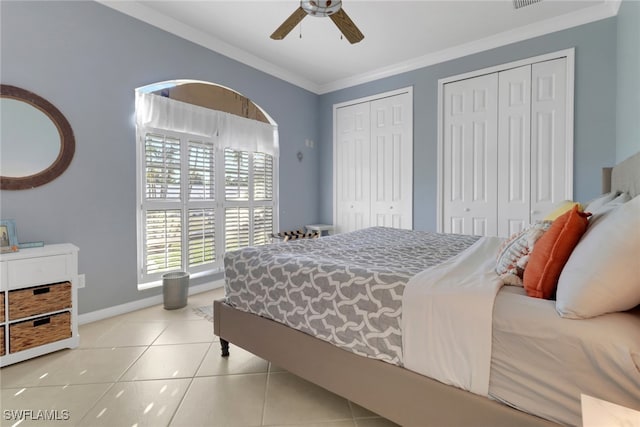 bedroom featuring multiple closets, ceiling fan, crown molding, and light tile patterned flooring