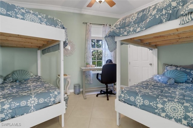 tiled bedroom with ceiling fan and ornamental molding