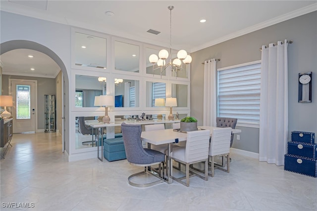 dining room with a notable chandelier and crown molding