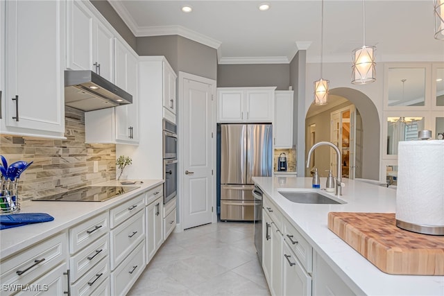 kitchen featuring white cabinets, sink, stainless steel appliances, and pendant lighting