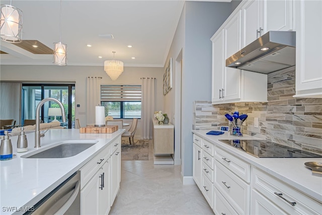 kitchen featuring decorative light fixtures, backsplash, stainless steel dishwasher, sink, and white cabinetry