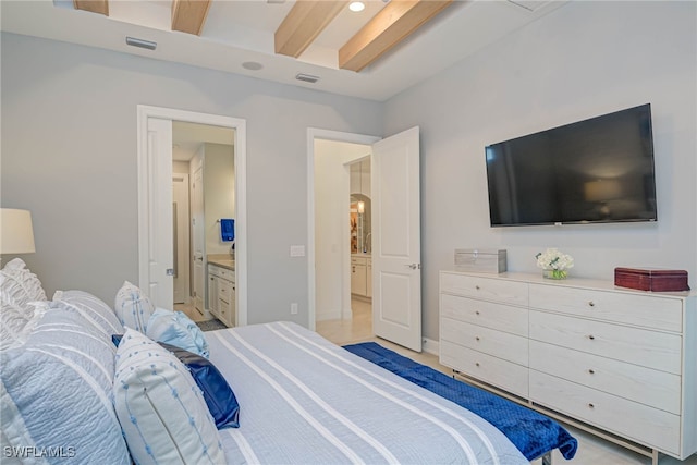 bedroom with ensuite bathroom and beam ceiling