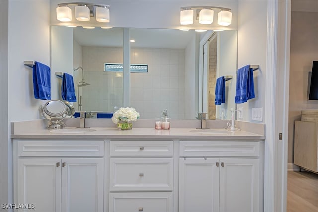 bathroom featuring vanity and tiled shower