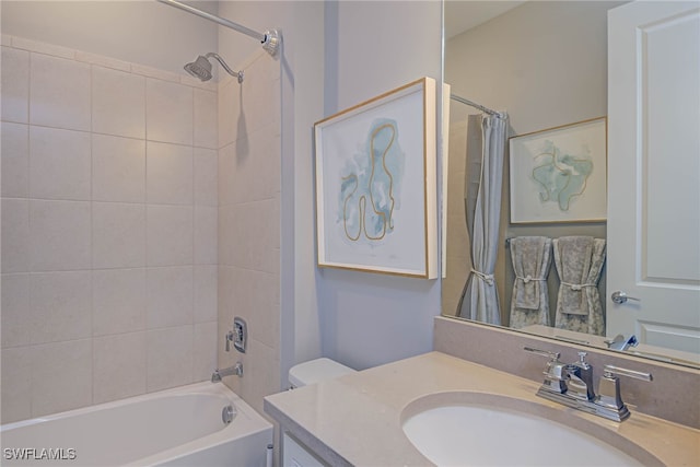 full bathroom featuring toilet, vanity, and shower / bath combo with shower curtain