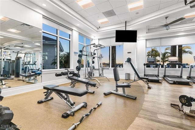 workout area featuring ceiling fan and a drop ceiling