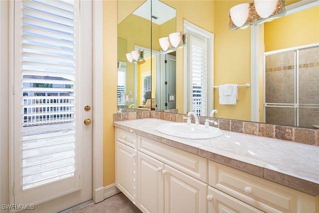 bathroom with vanity and an enclosed shower