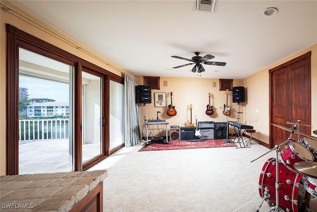 interior space with access to outside, ceiling fan, and light colored carpet