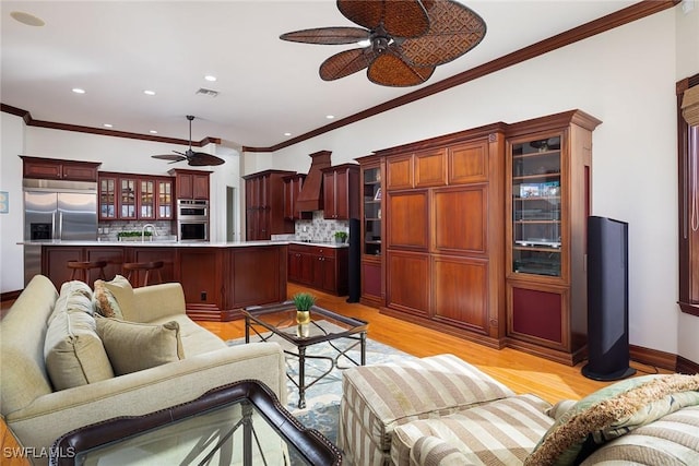 living room with light hardwood / wood-style flooring and crown molding