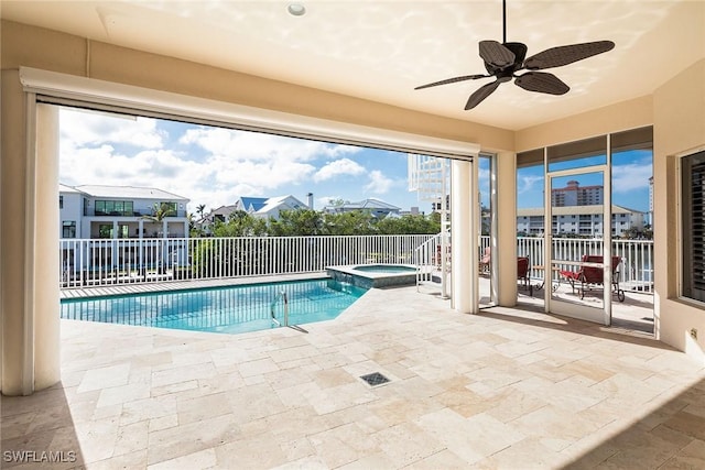 view of swimming pool with ceiling fan, a patio area, and an in ground hot tub