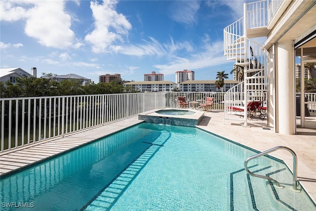 view of swimming pool with an in ground hot tub and a patio