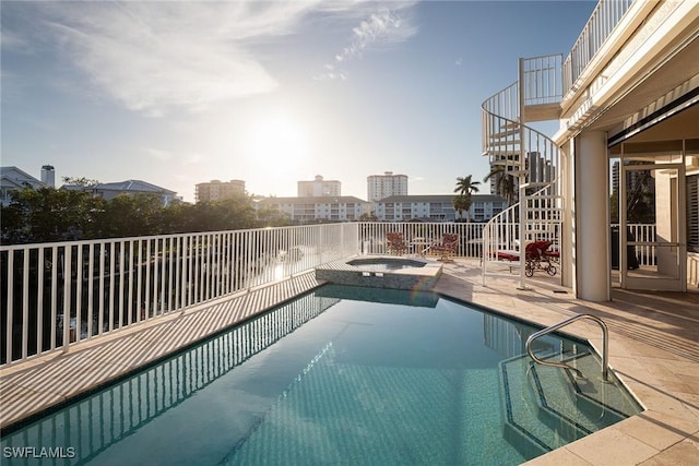 view of swimming pool with an in ground hot tub and a patio