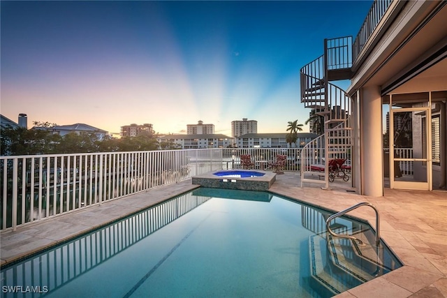 view of pool with stairs, a patio, and a pool with connected hot tub