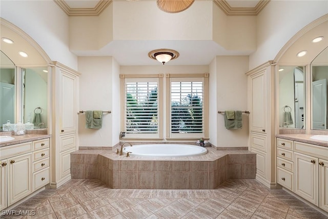 full bathroom with a towering ceiling, crown molding, a bath, and vanity