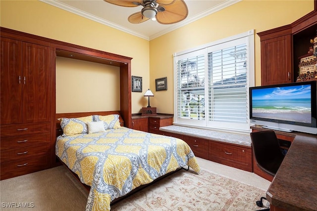 carpeted bedroom featuring a ceiling fan and crown molding