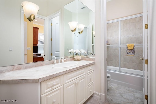 full bath featuring toilet, shower / bath combination with glass door, tile patterned flooring, and vanity