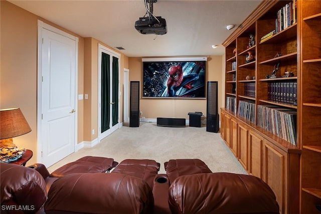 home theater with light carpet, visible vents, and baseboards