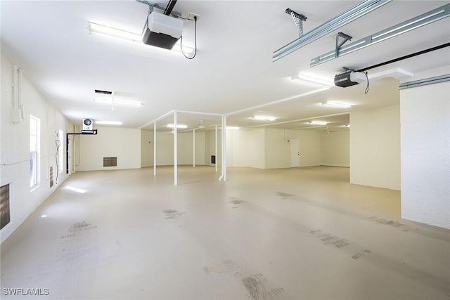 garage featuring visible vents and a garage door opener