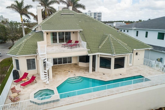 back of property featuring a patio area, a tile roof, and stairs