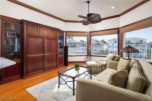 living area with light wood-style flooring, a residential view, ornamental molding, and ceiling fan