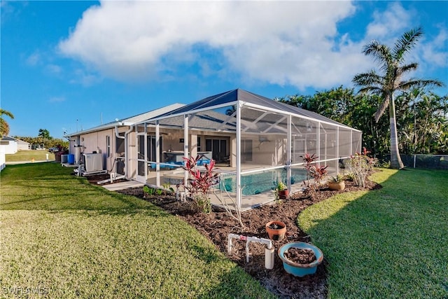 view of pool with a lanai and a lawn